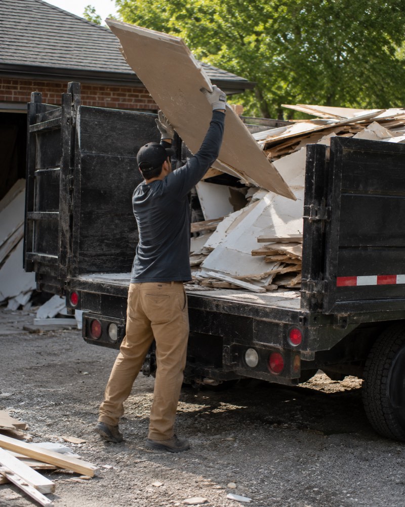 crew loading construction debris removal truck in Rockford IL